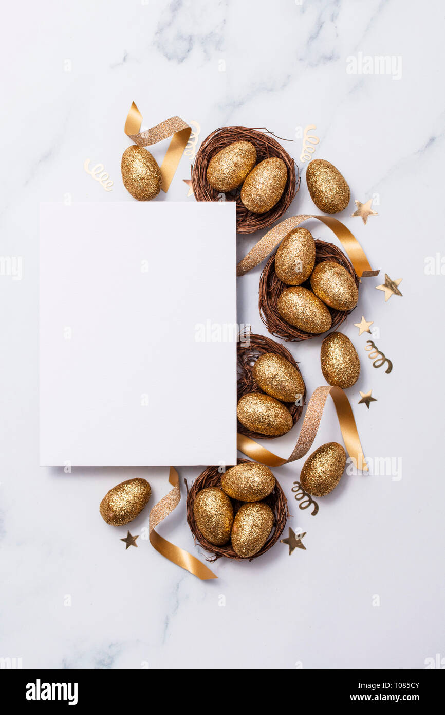 Easter composition. Blank card with gold eggs and nests Stock Photo
