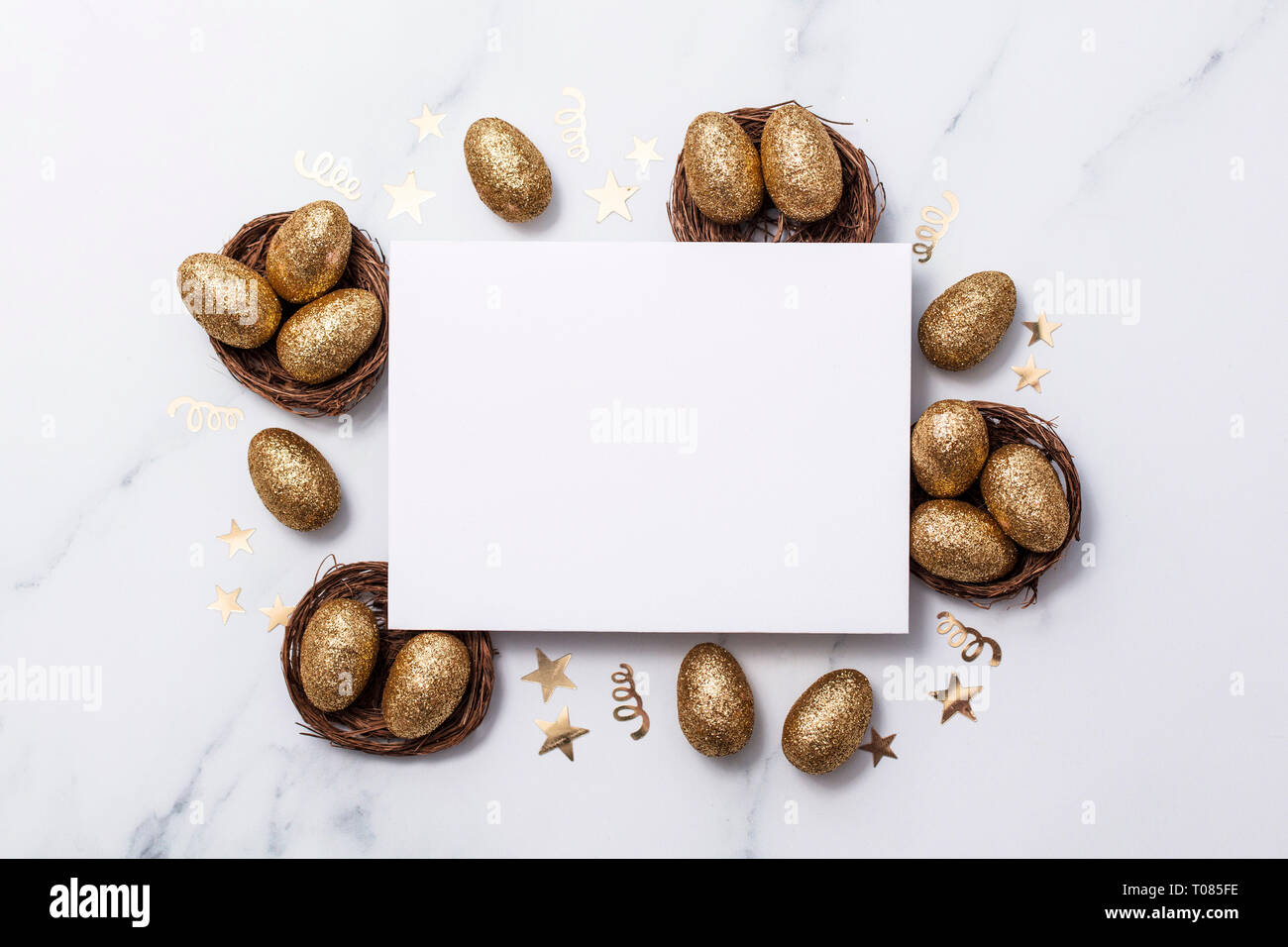 Easter composition. Blank card with gold eggs and nests Stock Photo