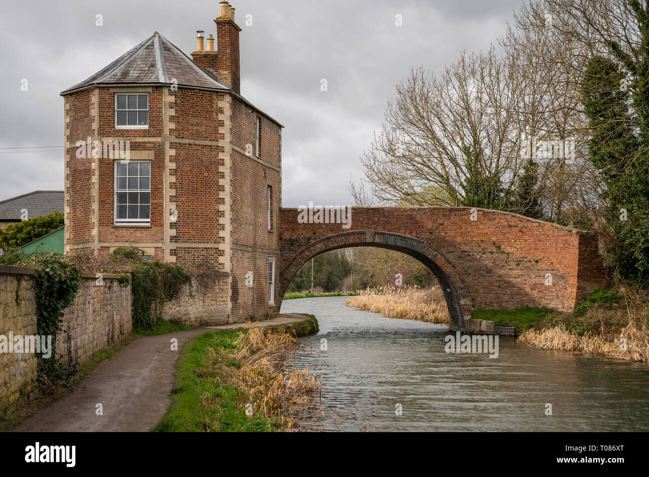 Nutshell Bridge and adjoing house on the Stroudwater Navigation near Stonehouse Stroud, England. The bridge and house were built in 1778 and are Grade Stock Photo