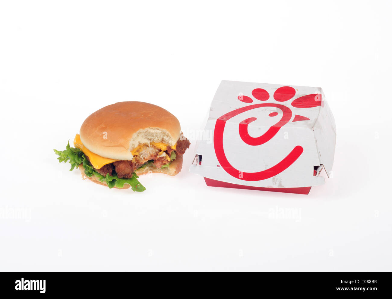 ChickFilA chicken fillet, lettuce, cheese sandwich on a bun with bite