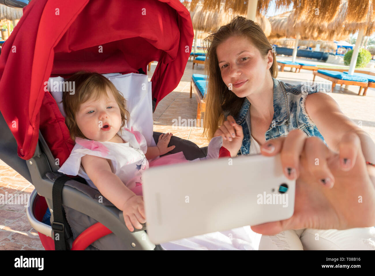 Mother taking selfie with baby girl on resort Stock Photo