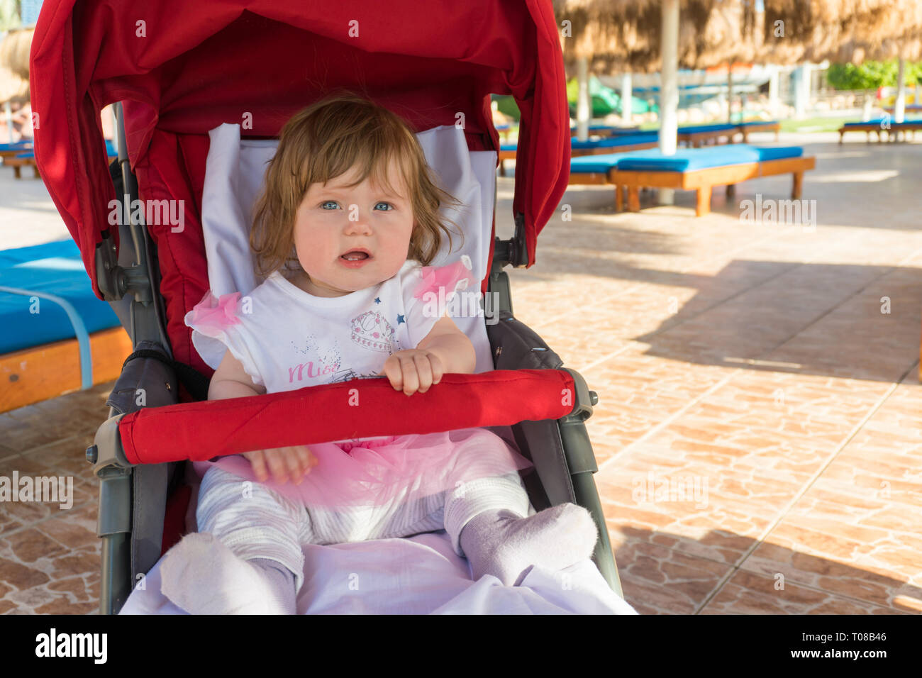 Baby in carriage on resort on the beach Stock Photo - Alamy