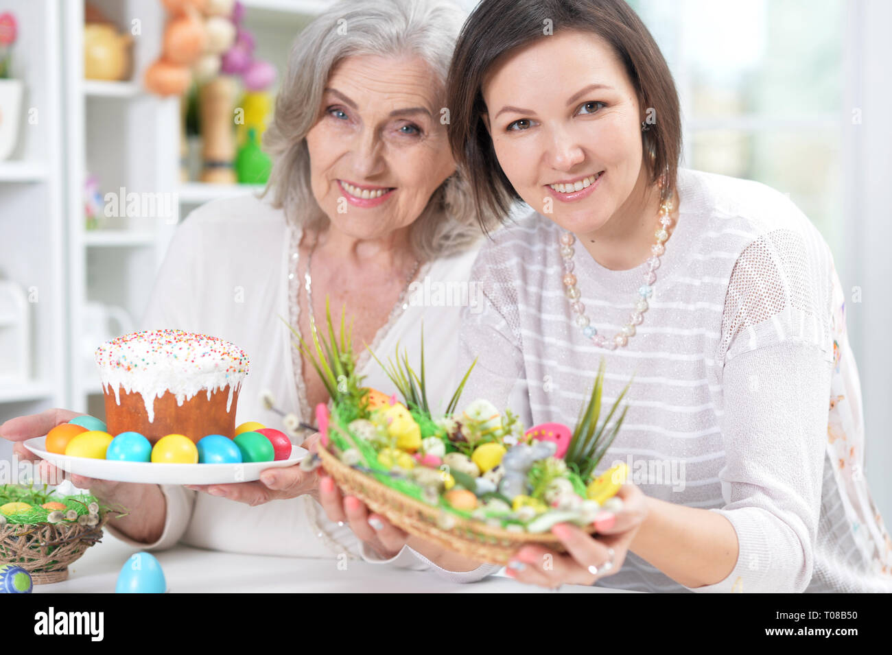 Close-up portrait of mother and daughter colouring eggs Stock Photo
