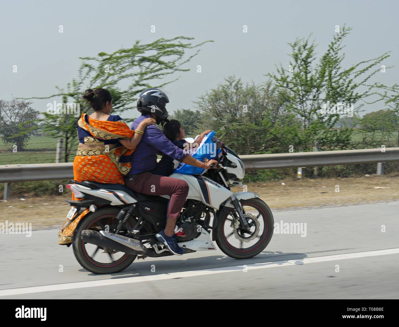 NEW DELHI, INDIA—MARCH 2018: A family rides on a motorcycle in New Delhi. Stock Photo