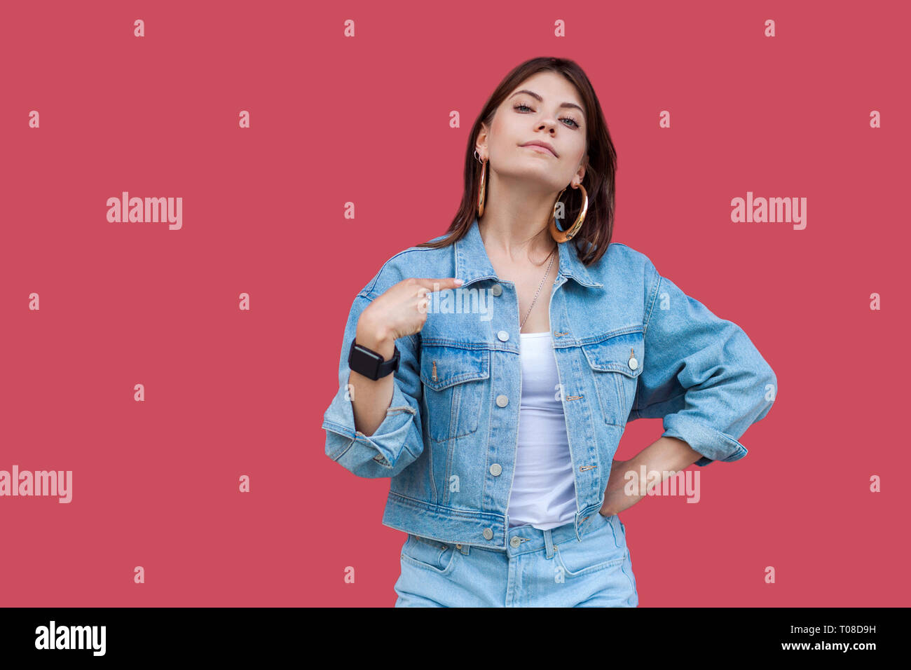 Portrait of proud beautiful brunette young woman with makeup in denim casual style standing, pointing herself and looking at camera with haughty face. Stock Photo