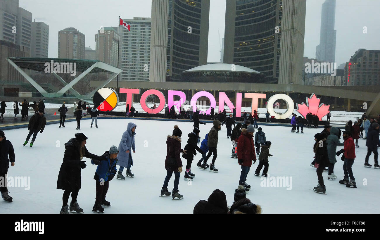 People ice skating on Toronto's famous ice rink at Nathan Phillips