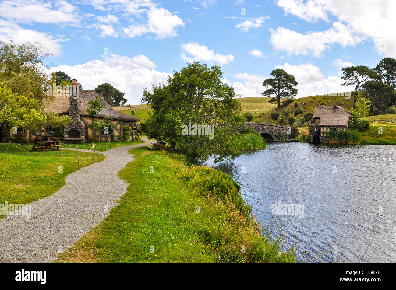 Hobbiton Movie Set - Location for the Lord of the Rings and The Hobbit films. Bag End lake, mill. Visitor attraction in Waikato region New Zealand Stock Photo