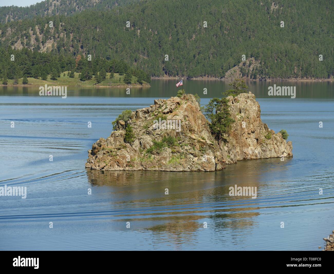 Wide shot of an islet at Lake Pactola, the largest reservoir in the