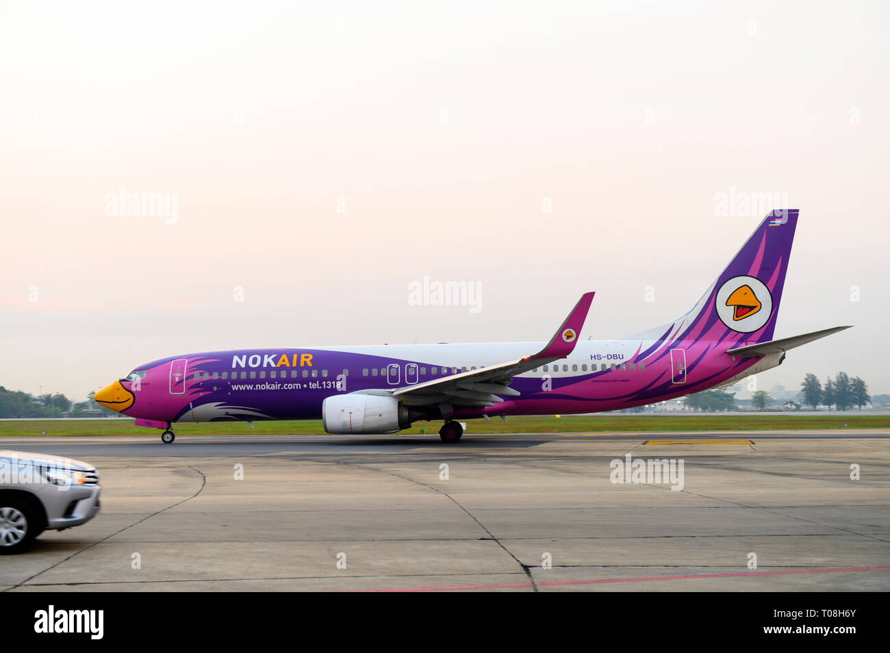 Boeing 737-800 airplane of Nok Air taxiing on runway of Don Muang Airport Stock Photo