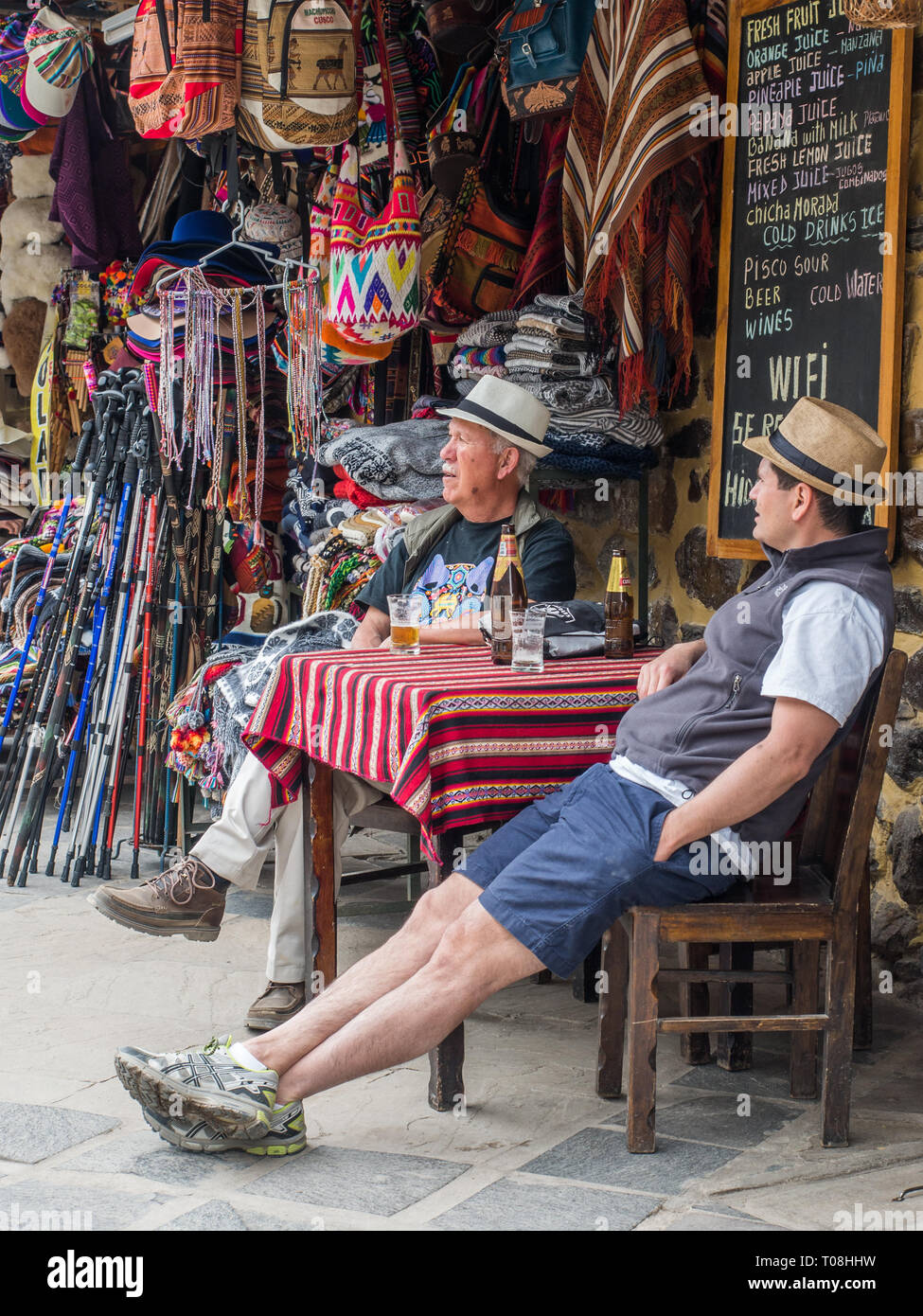 Ollantaytambo, Peru - May 20, 2016: Two men in the Panama hat siiting in trhe restaurant on the way to Machu Picchu. South America. Stock Photo
