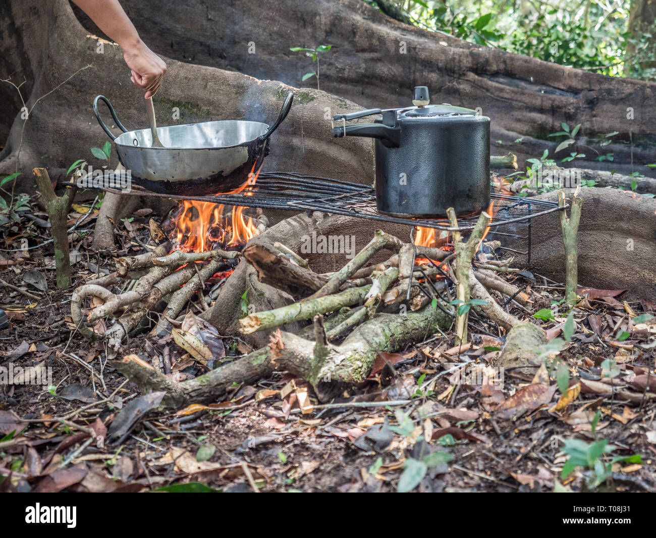 Lagoon, Brazil - November  27, 2017: Cooking on the fireplece on the camp in the amazons jungle Stock Photo