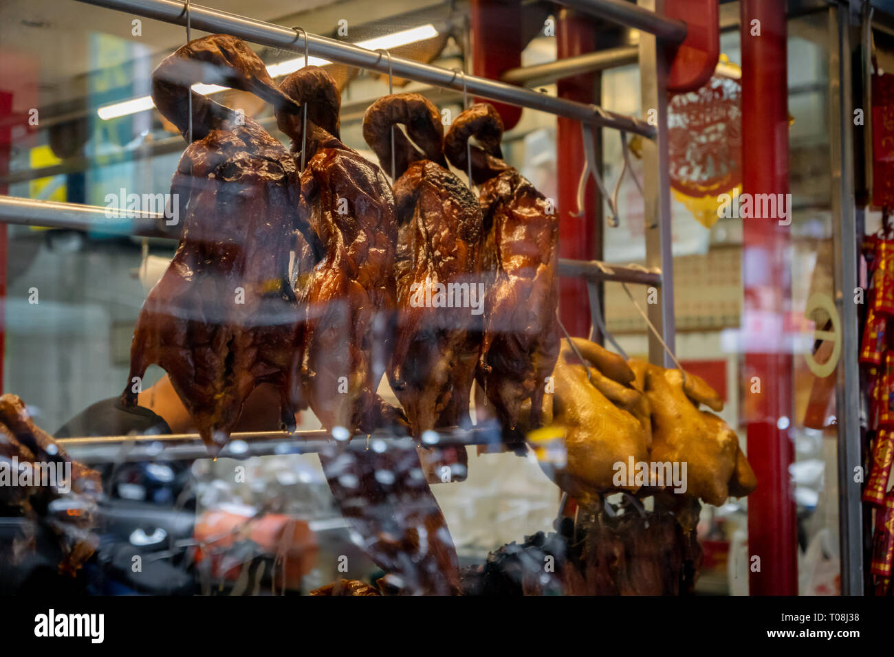 Roasted Peking ducks hanging in front of Chinese restaurant Stock Photo