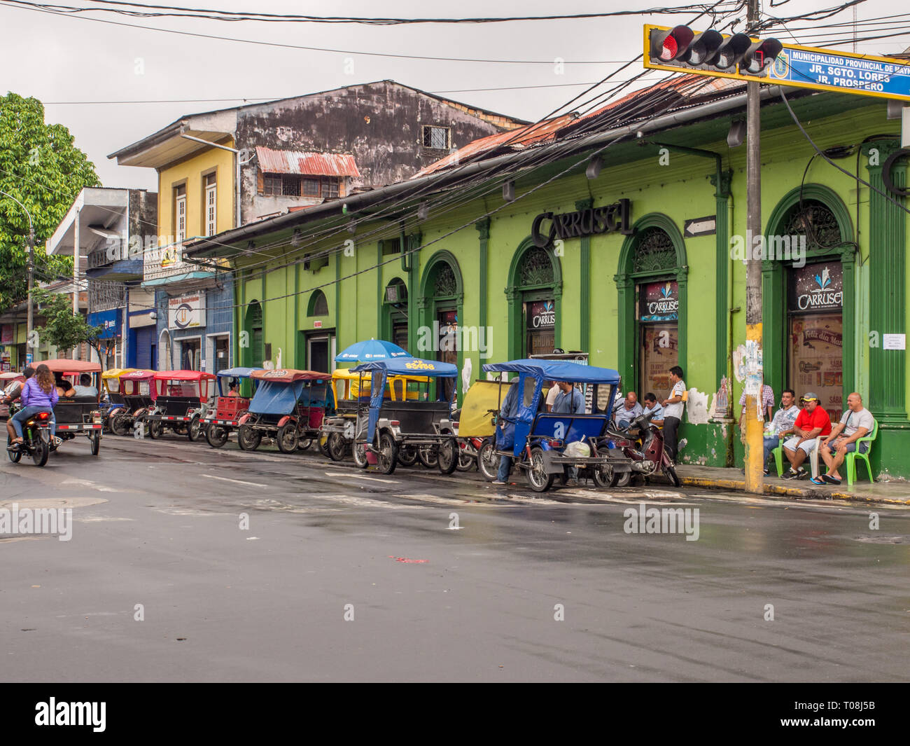 Iquitos, Peru- May 14, 2016: Various rickshaws on a  street of a small town. Stock Photo