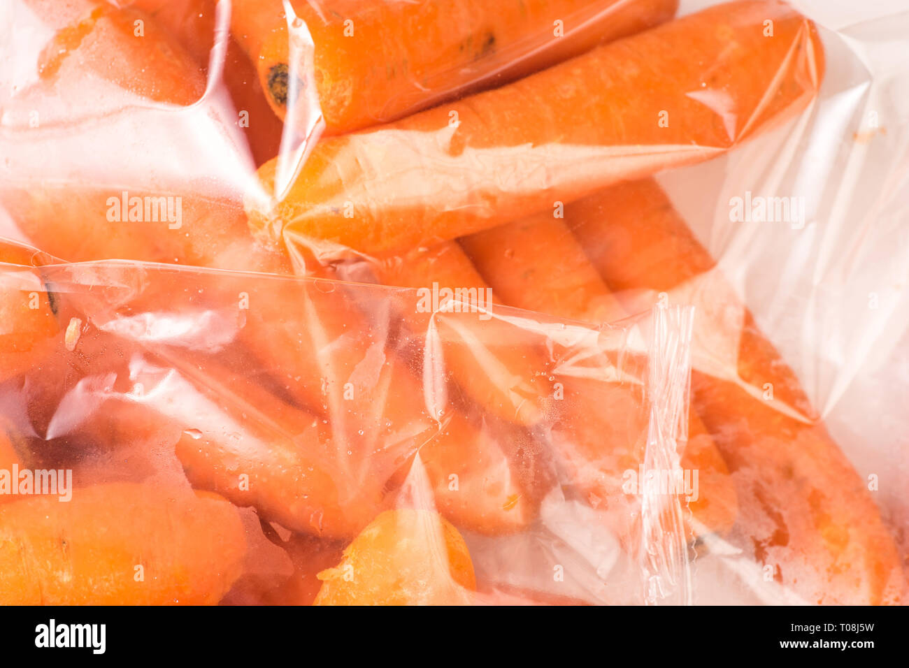 Bunch of organic Carrots packaged in plastic bag Stock Photo