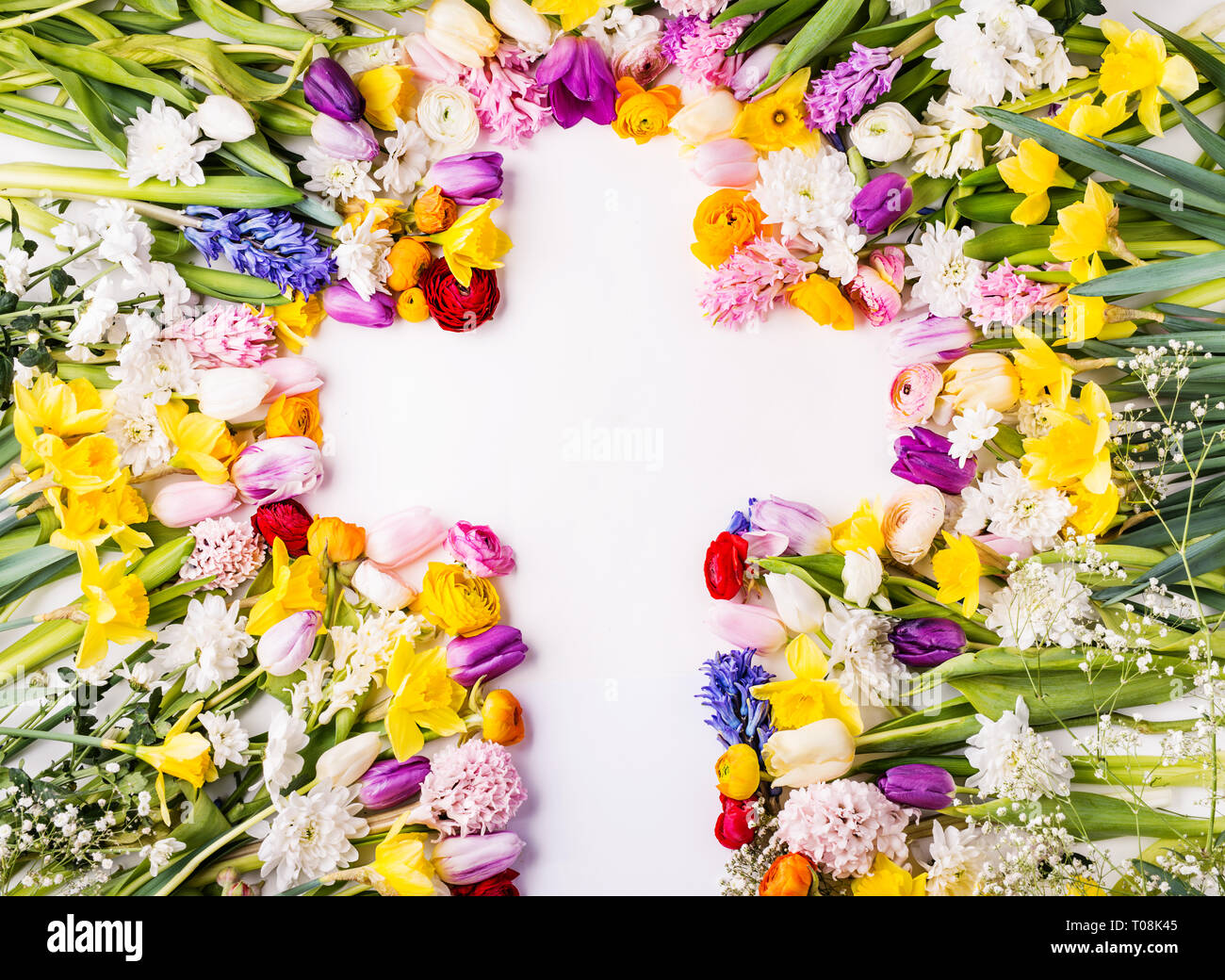 Flowers and cross Easter abstract concept on a white background. Copy space. Stock Photo