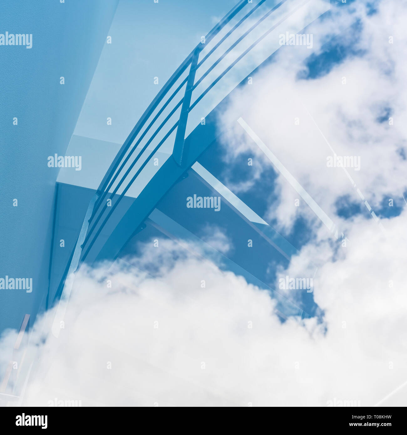 reflection of stairs in glass window seem to lead into the clouds in ...