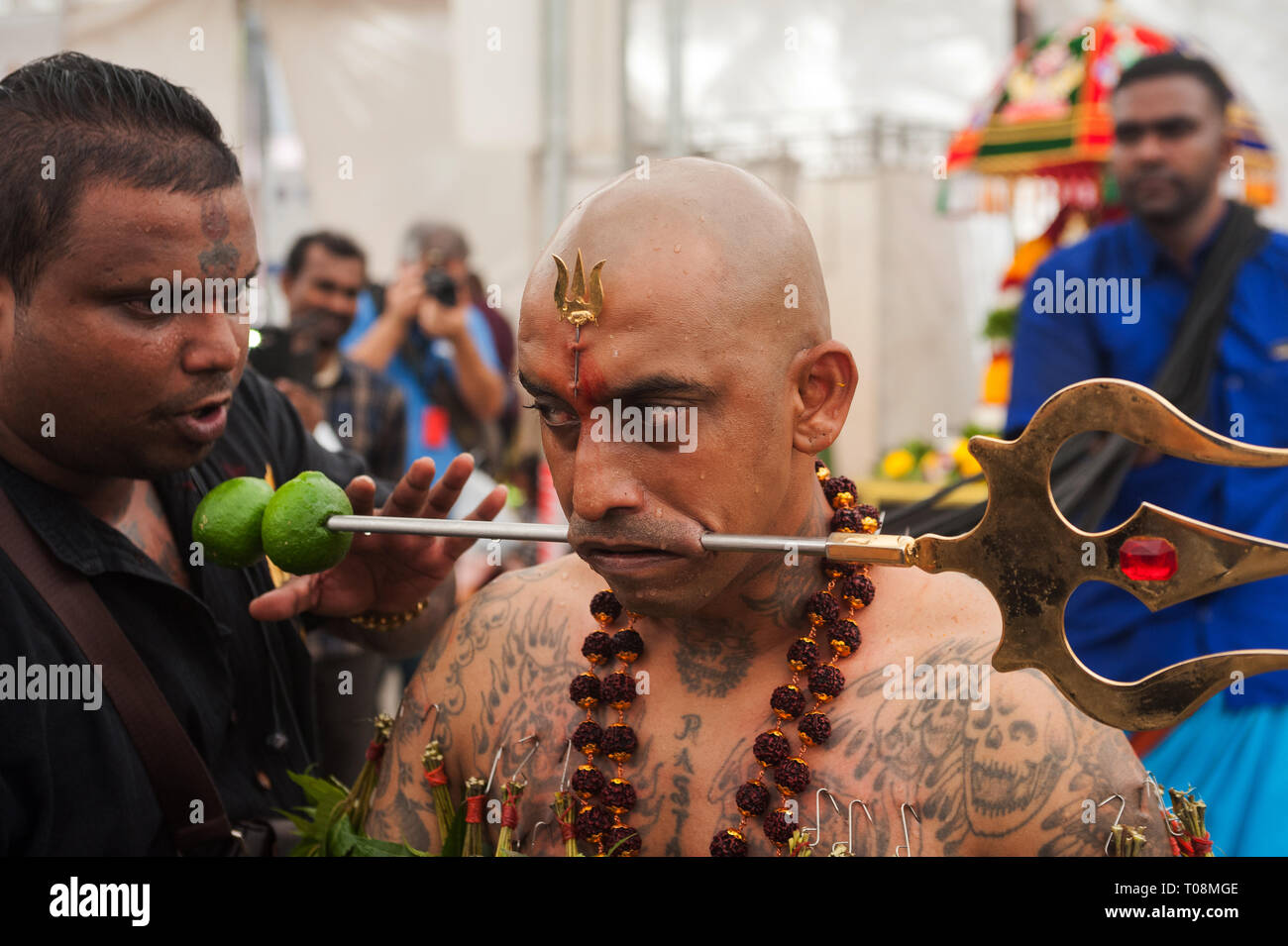31.01.2018, Singapore, Singapore - The jaws of a believing Hindus are pierced with a metal skewer as he prepares for the procession at the Sri Sriniva Stock Photo