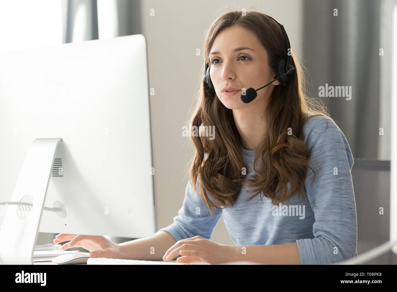 Businesswoman in headset call center agent consulting participating video conference Stock Photo