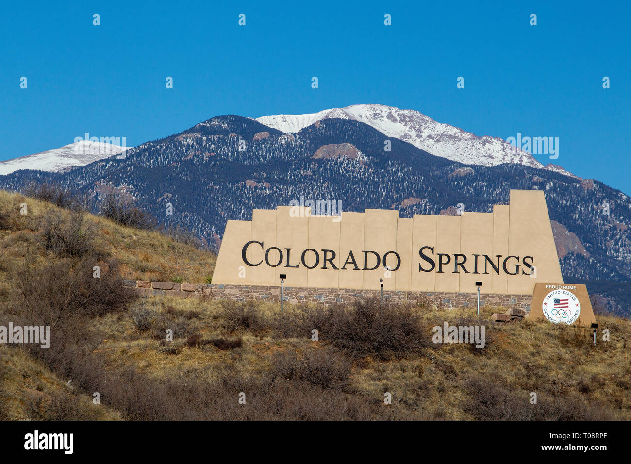 Welcome sign to Colorado Springs, Colorado with snow covered Pikes Peak in the background. Stock Photo