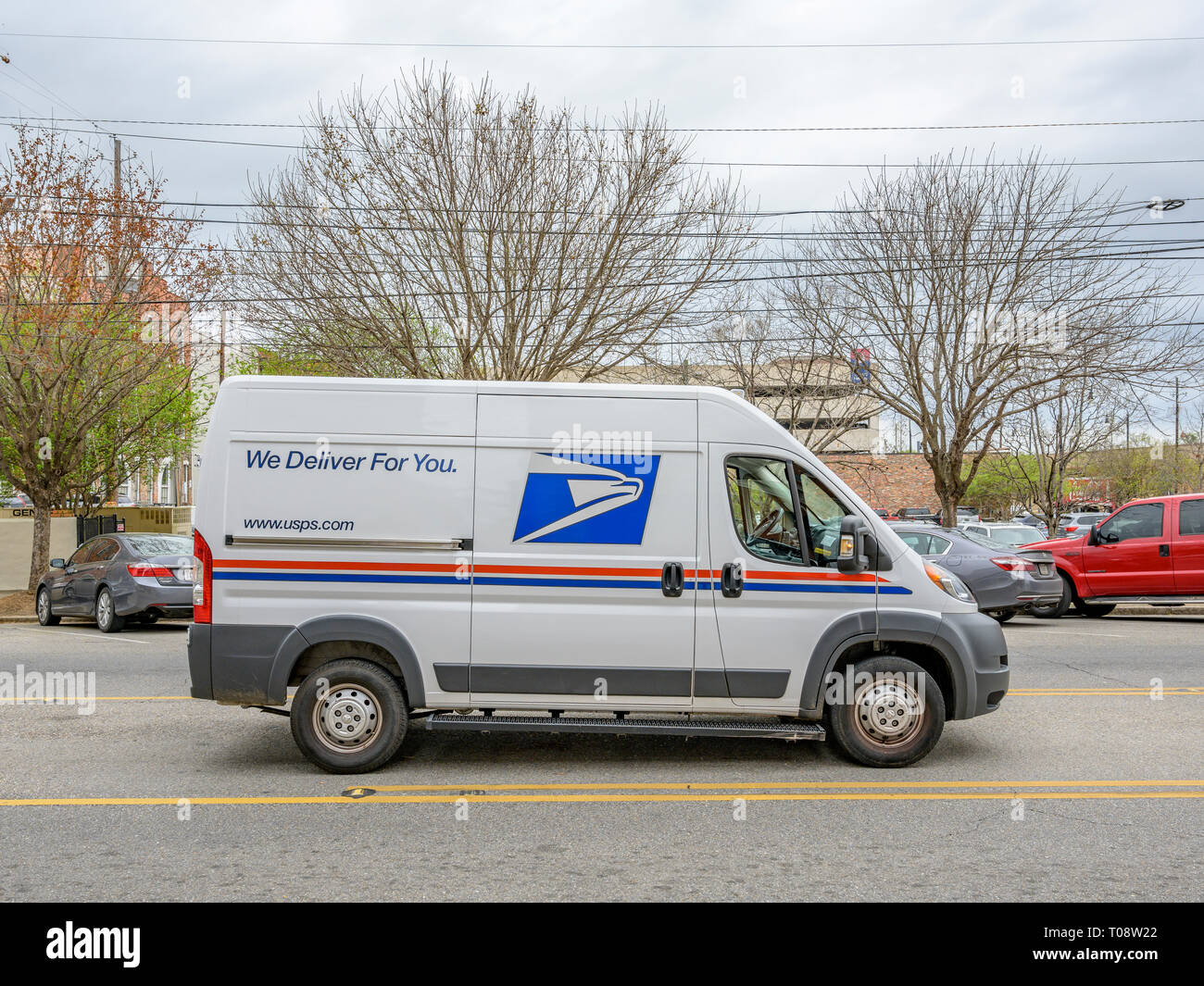 New modern U.S. Postal Service delivery van or mail truck parked on a city street making deliveries in downtown Montgomery Alabama, USA. Stock Photo