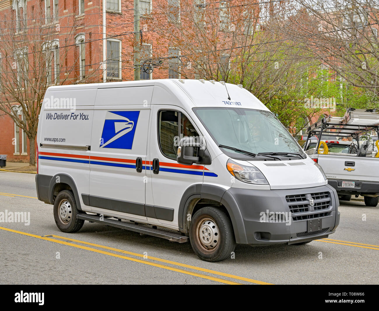 New modern U.S. Postal Service delivery van or mail truck parked on a city street making deliveries in downtown Montgomery Alabama, USA. Stock Photo