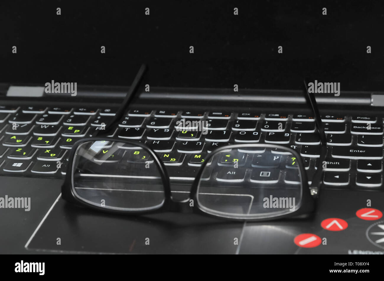 Reading glasses and laptop keyboard Stock Photo Alamy