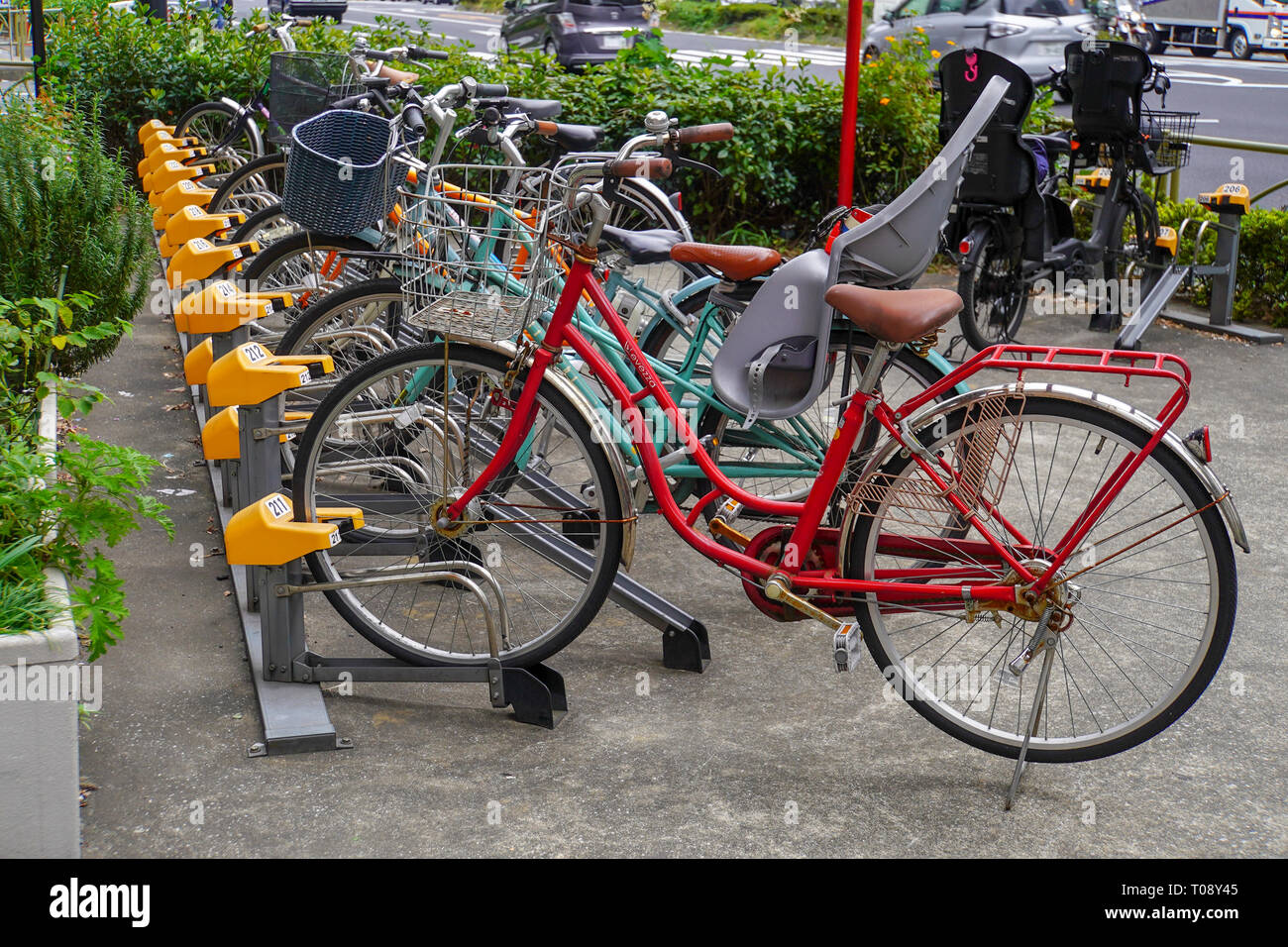 Row of parked bicycles in central Tokyo, a popular form of transport in Japan Stock Photo