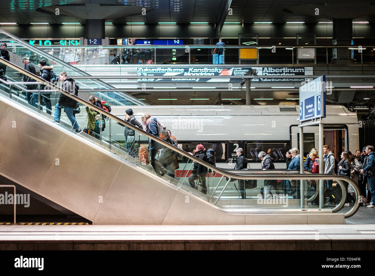 Berlin, Germany - march 2019: People with luggage on escalator inside main train station (Hauptbahnhof) in Berlin, Germany Stock Photo