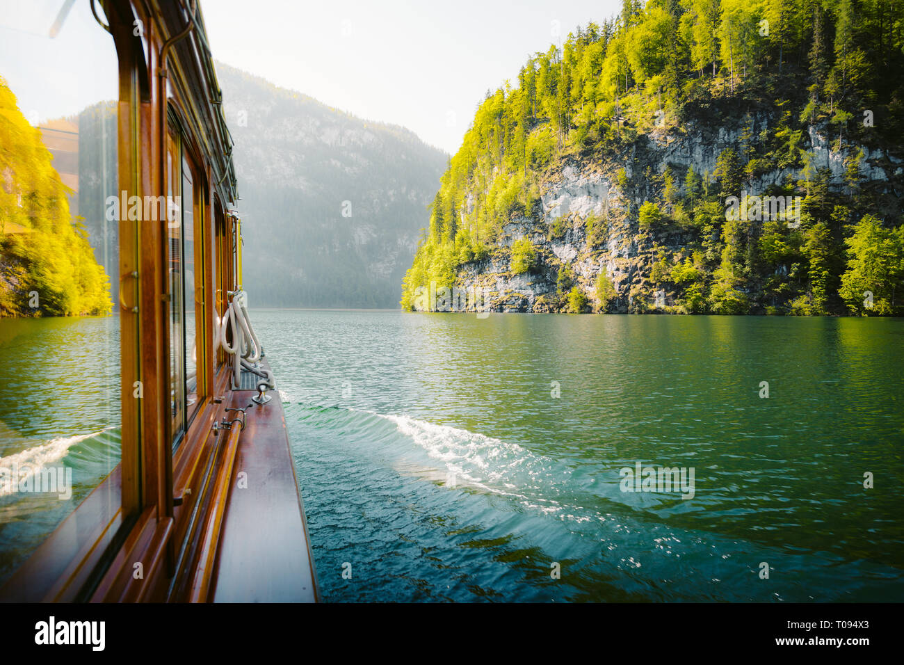 Traditional passenger boat gliding on Lake Konigssee with Watzmann mountain in the background on a beautiful sunny day in summer, Berchtesgadener Land Stock Photo