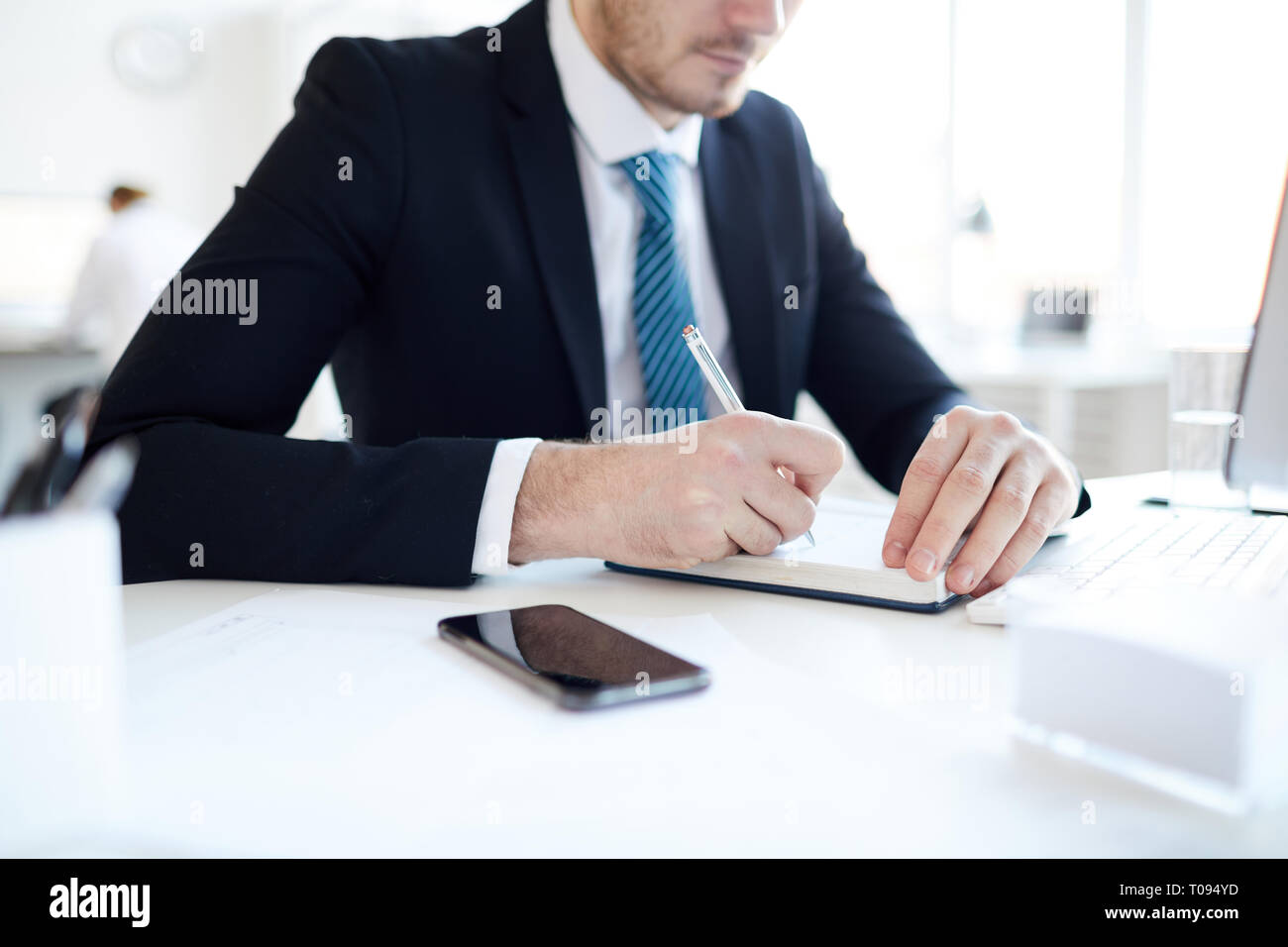 Making notes by workplace Stock Photo - Alamy
