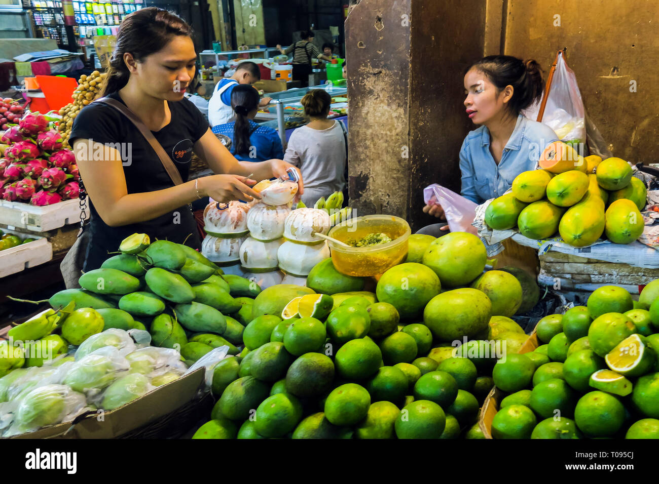 Fruit stall with mangoes, oranges, & papaya, the Psar Chas Old Market in the centre of this NW tourist town; Siem Reap, Cambodia Stock Photo