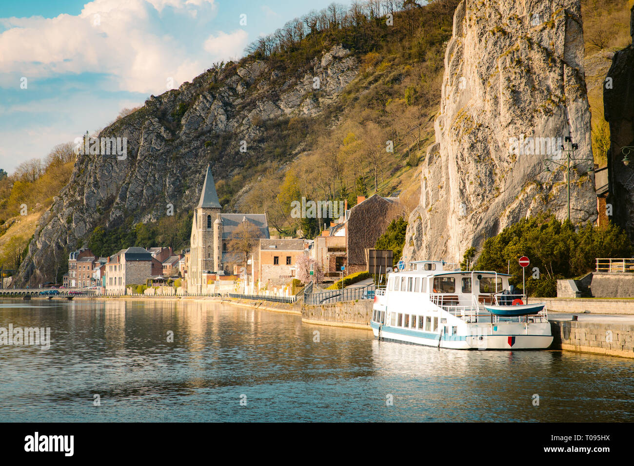 Panoramic view of scenic Meuse river with famous Bayard Rock and the historic town of Dinant in the background in beautiful golden evening light at su Stock Photo