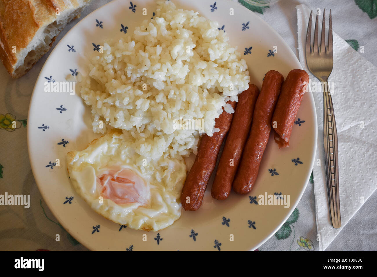 Plate with sausages and fried egg with rice Stock Photo