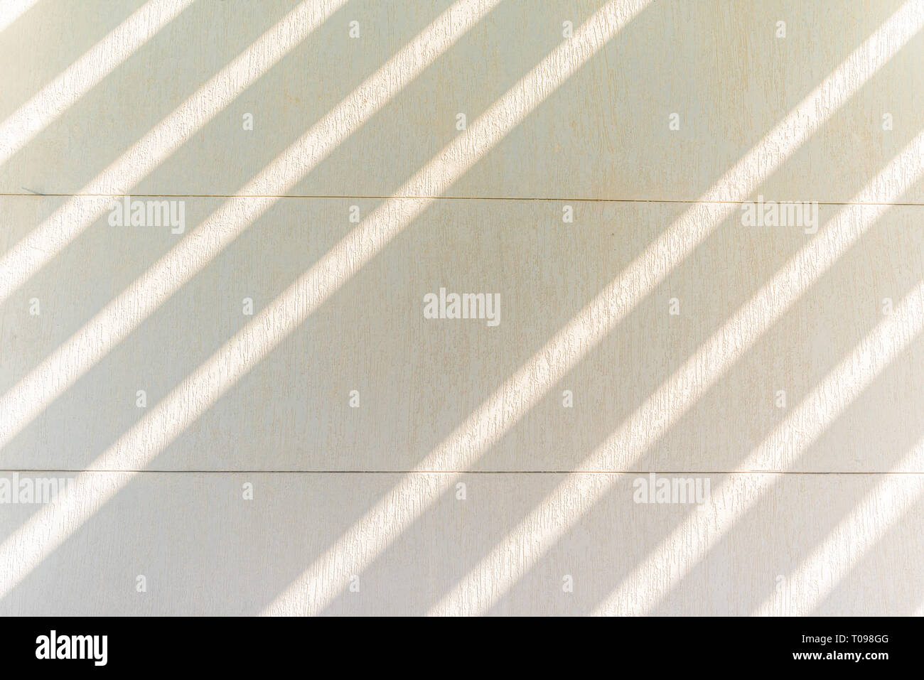 Textured white wall and rays of sunlight, Umm Al Emarat Park, Abu Dhabi, United Arab Emirates Stock Photo