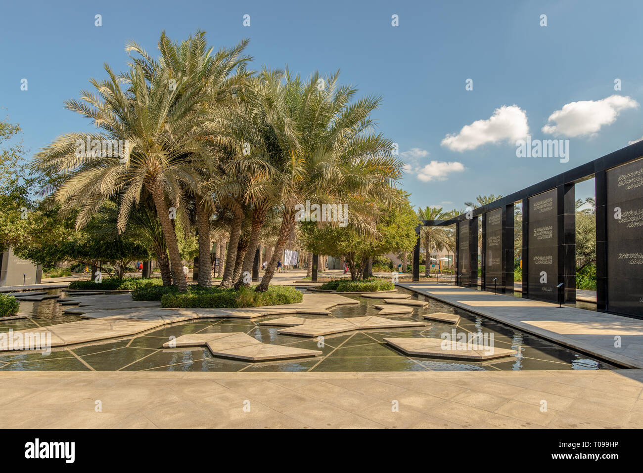 Clump of date trees and memorial, Umm Al Emarat Park, Abu Dhabi, United Arab Emirates Stock Photo