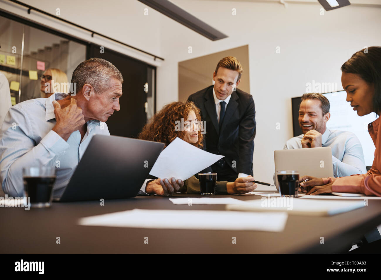 Group discussion happy paperwork hi-res stock photography and images ...