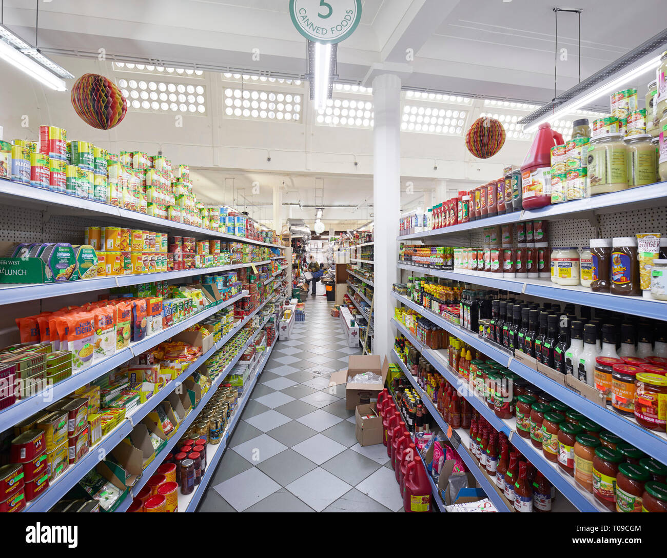 Supermarket aisle. Khan's Department Store Peckham, London, United Kingdom. Architect: Benedict OLooney Arch, 1935. Stock Photo