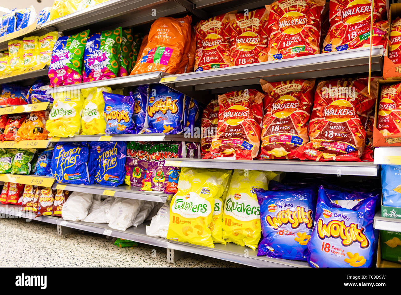 Crisps and snacks for sale in a supermarket, UK. Stock Photo