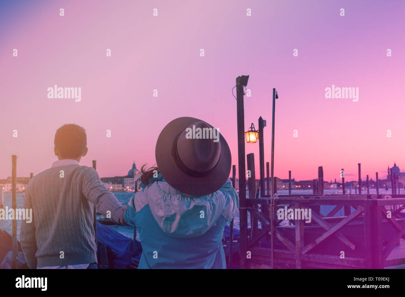 Couple in Venice on Gondola taking follow me selfie in front of
