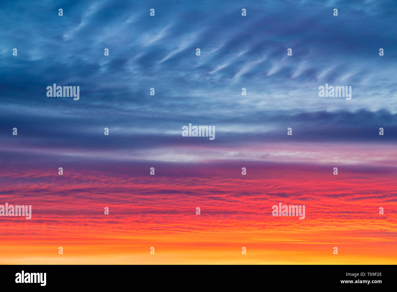 Beautiful cloudscape with colorful contrasting clouds at sunset Stock Photo