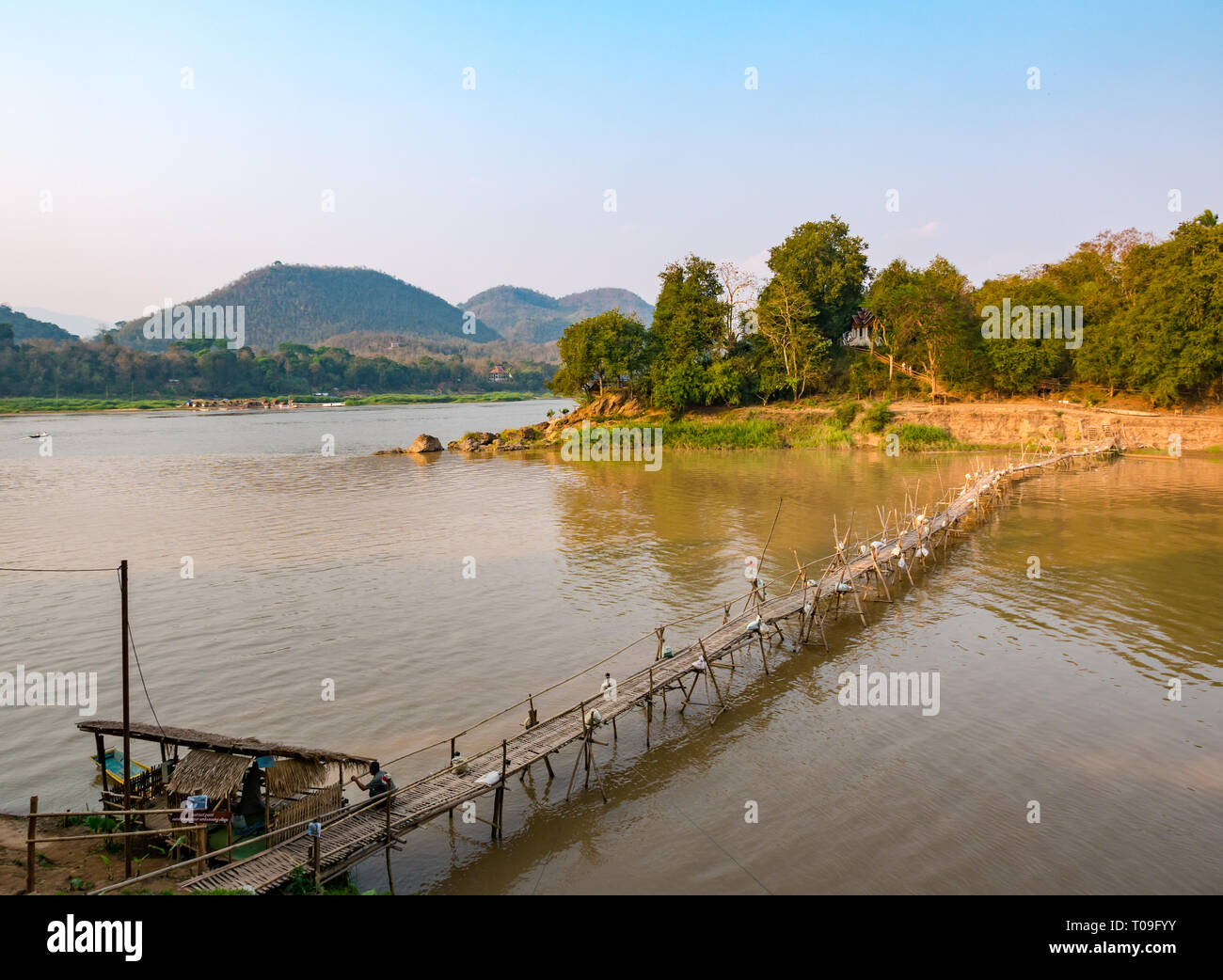 View of Mekong river with rickety bamboo cane bridge over Nam Kahn river tributary of Mekong, Luang Prabang, Laos, Indochina, SE Asia Stock Photo
