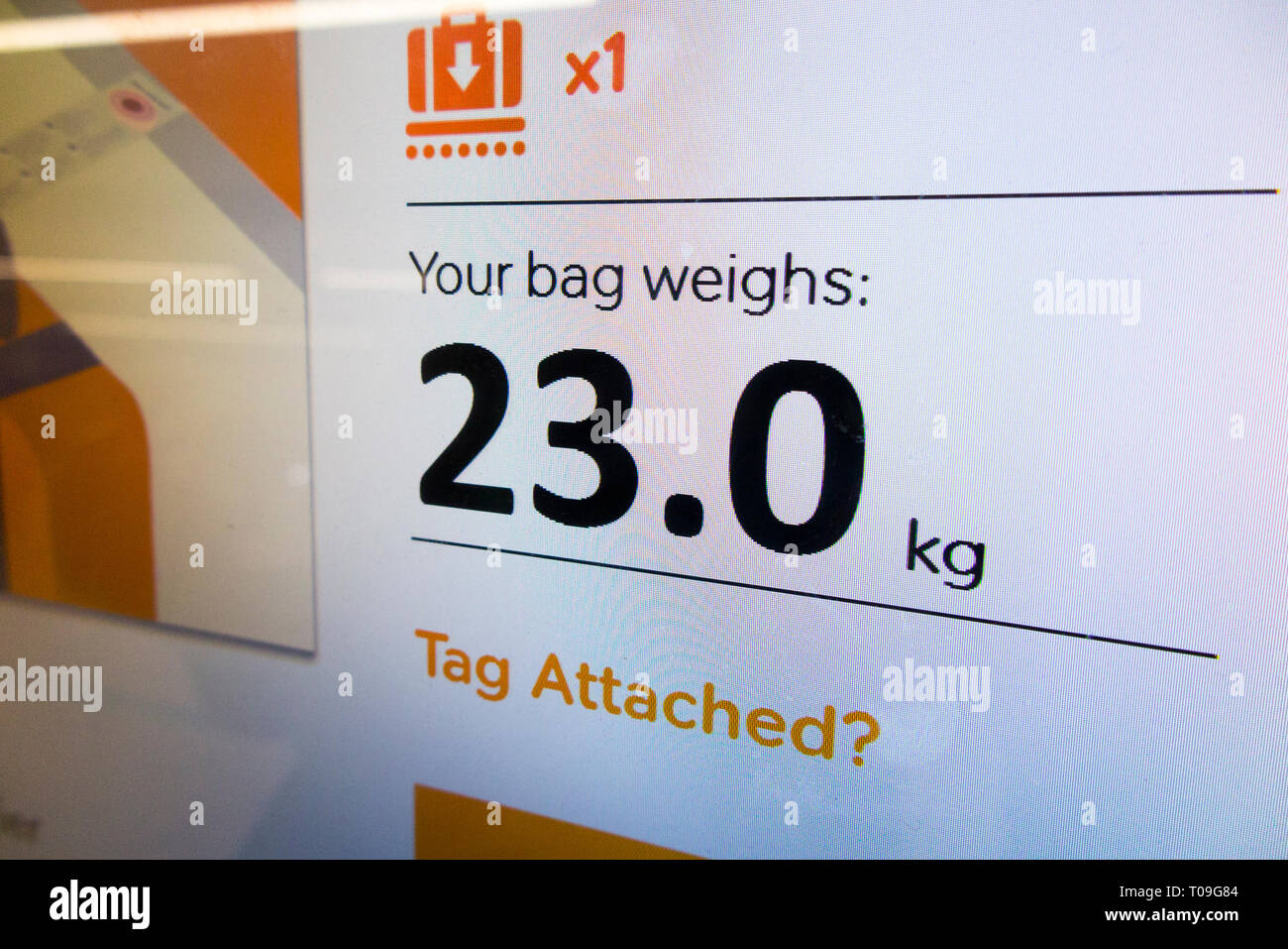 Airport check in weighing scale showing 23 kg kilograms / scales display to weigh passenger bags baggage / luggage weight checked into the plane hold. (104) Stock Photo