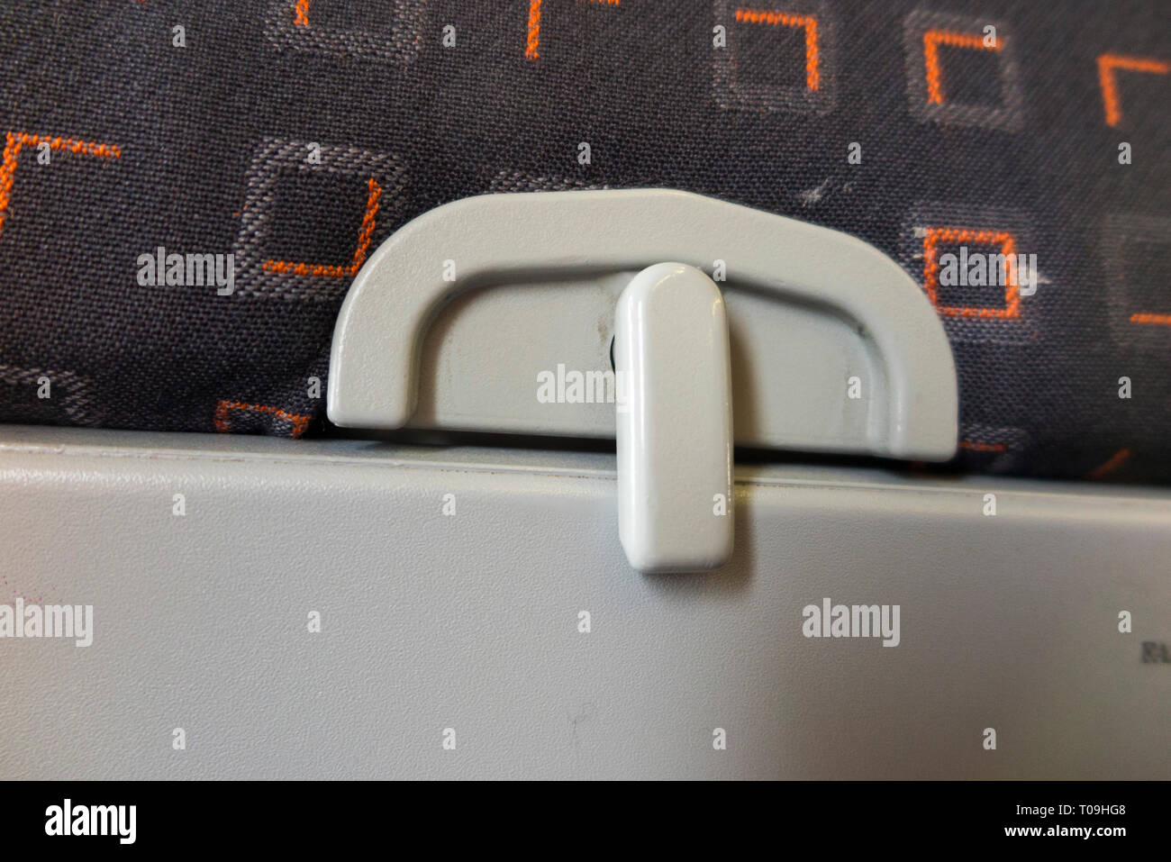 The latch / catch of a passenger 's seat tray table in folded up