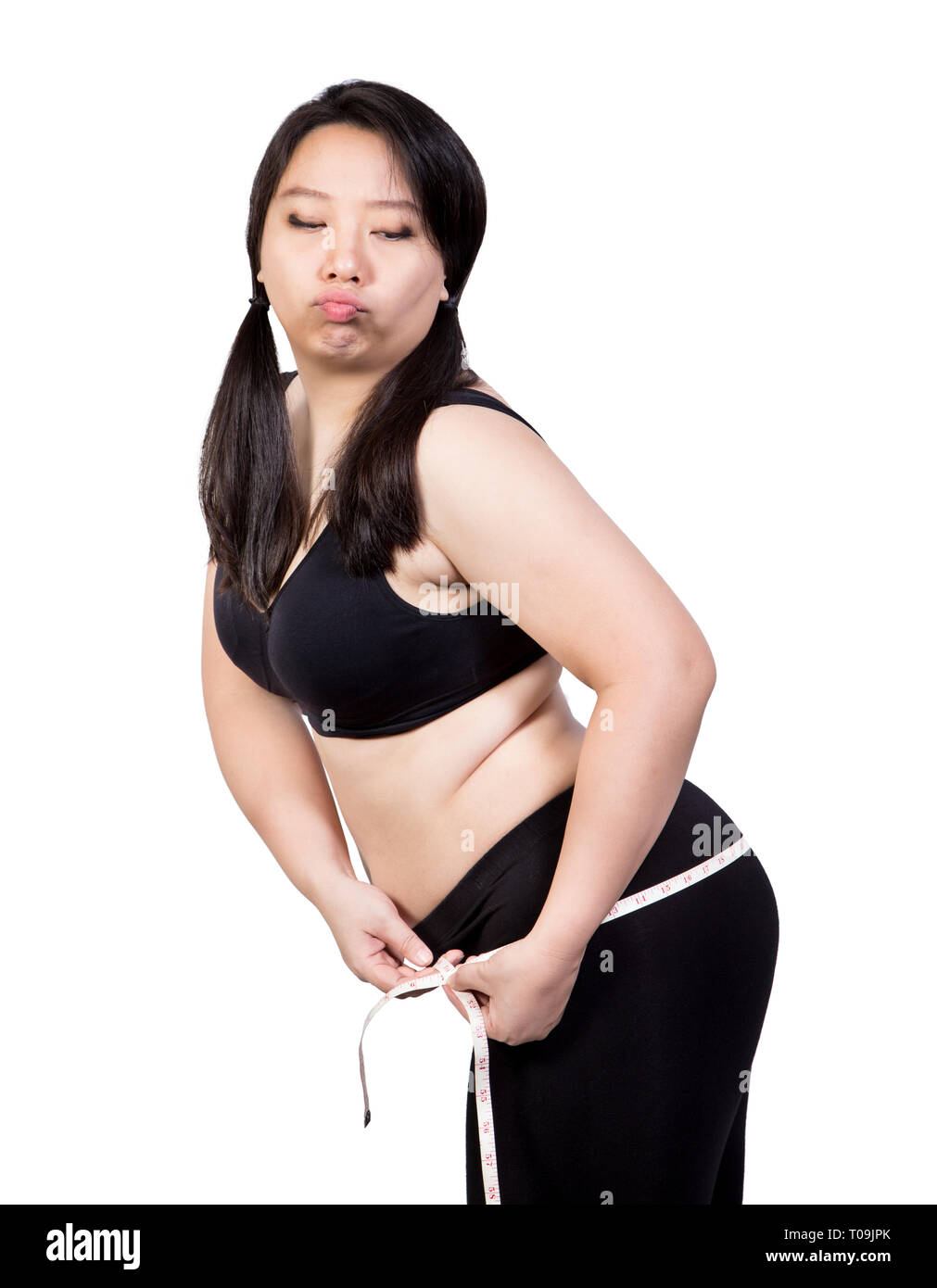 Fat Woman show overweight body tight obese by measuring tape at hip bored face weight loss concept isolated on white background Stock Photo