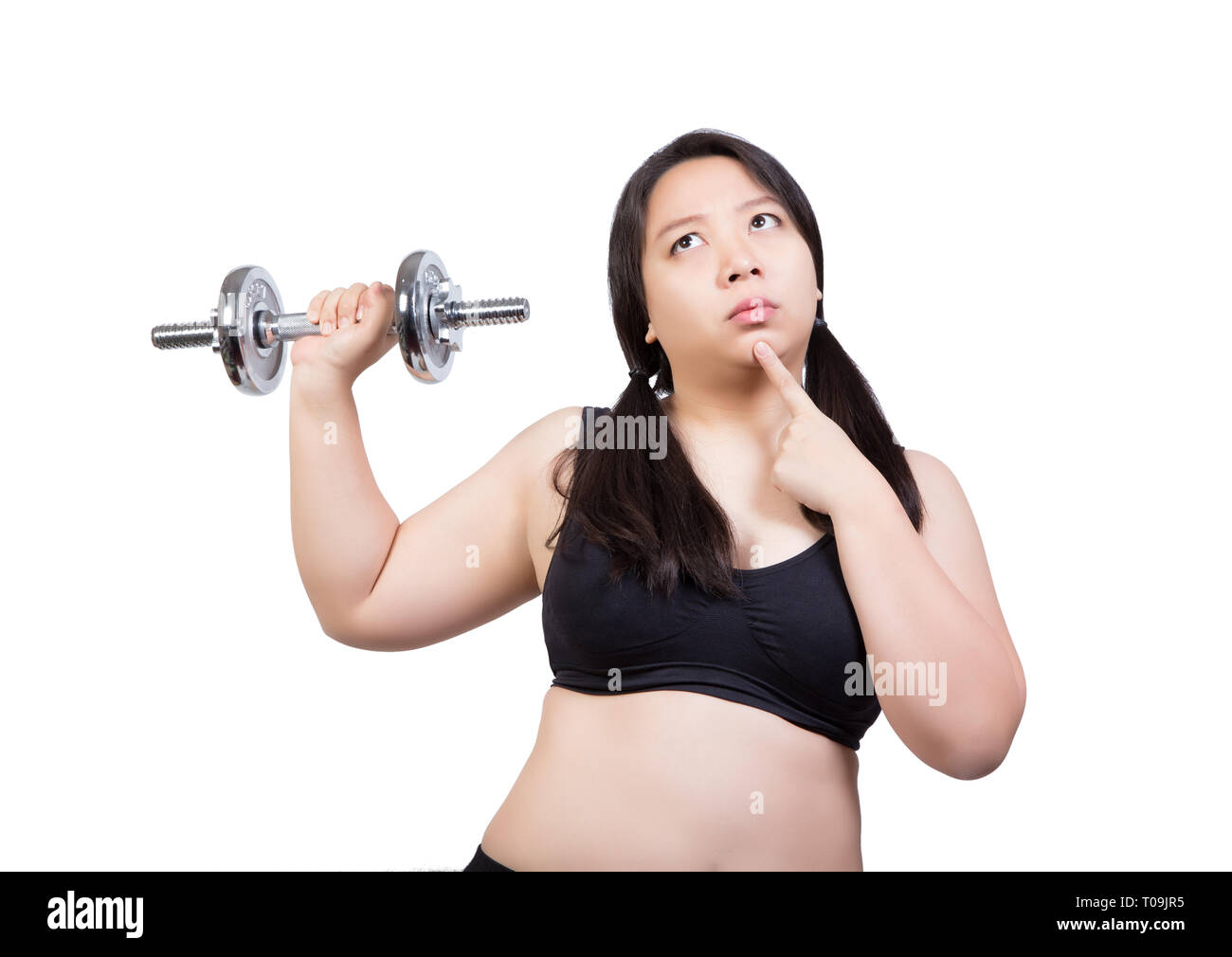 beautiful chubby fat woman lift dumbbell finger point to chin doubt about exercise weight training Stock Photo