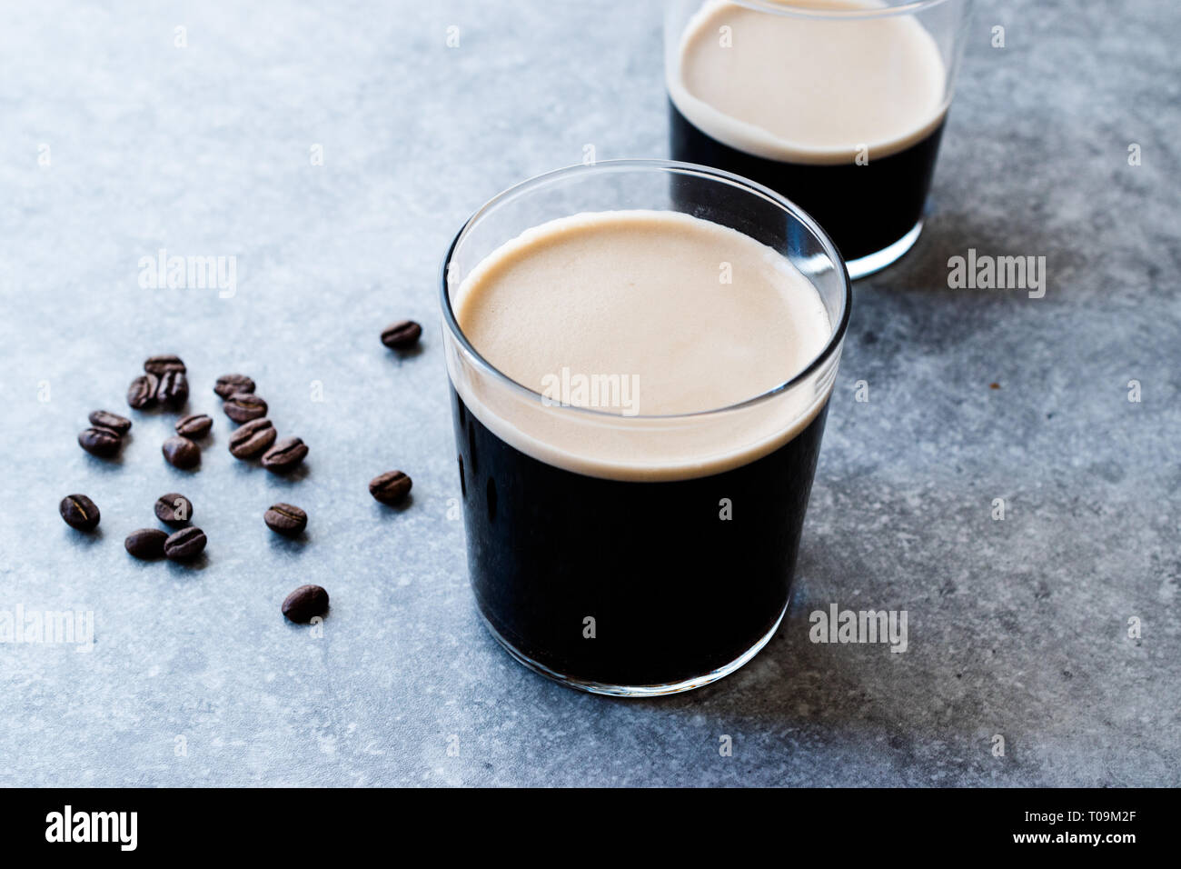 Frothy Cold Brew Nitro Coffee with Beans Ready to Drink. Organic Beverage with Caffeine Stock Photo