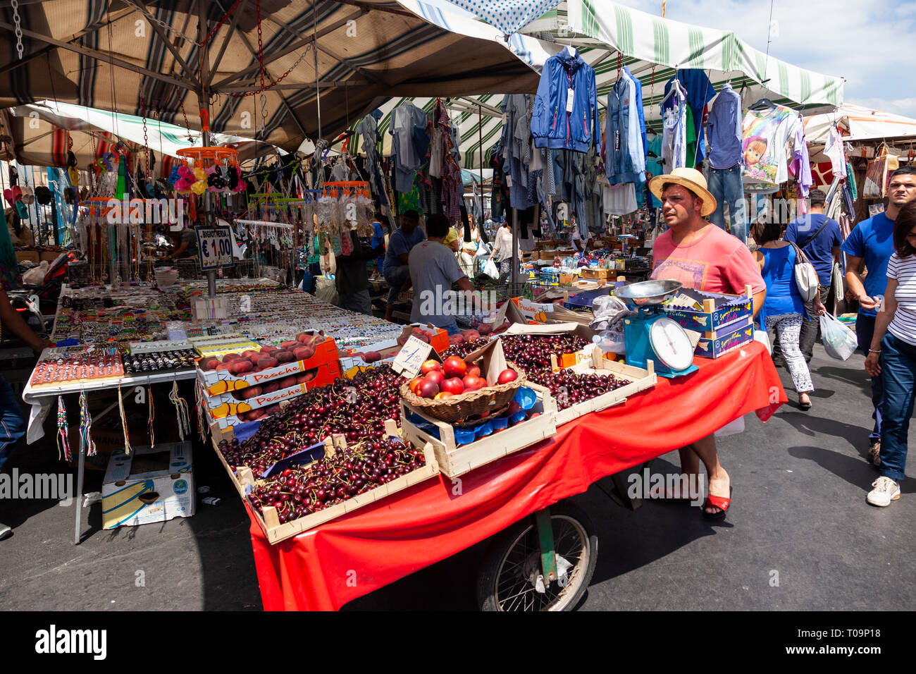 Fruit cart being pushed through a flea market in Catania, Sicily, Italy Stock Photo