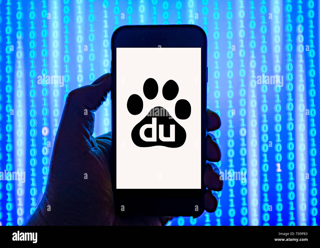 Person holding smart phone with Baidu logo displayed on the screen. Stock Photo