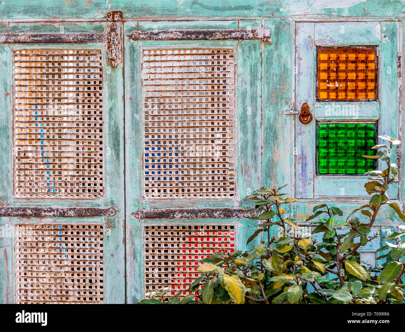 old cuban style wooden door with grid andd colorful windows Stock Photo