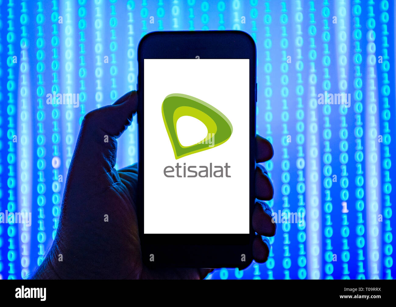 Person holding smart phone with Etisalat mobile phone company  logo displayed on the screen. Stock Photo
